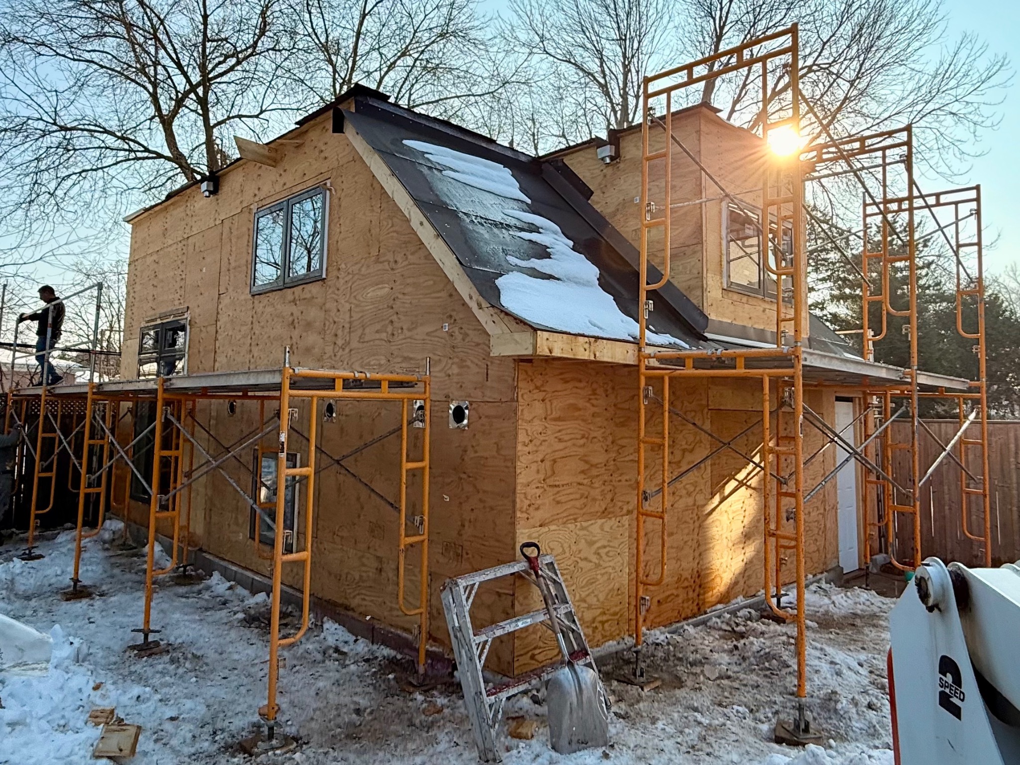 Building fully enclosed with structural wood sheathing during winter construction
