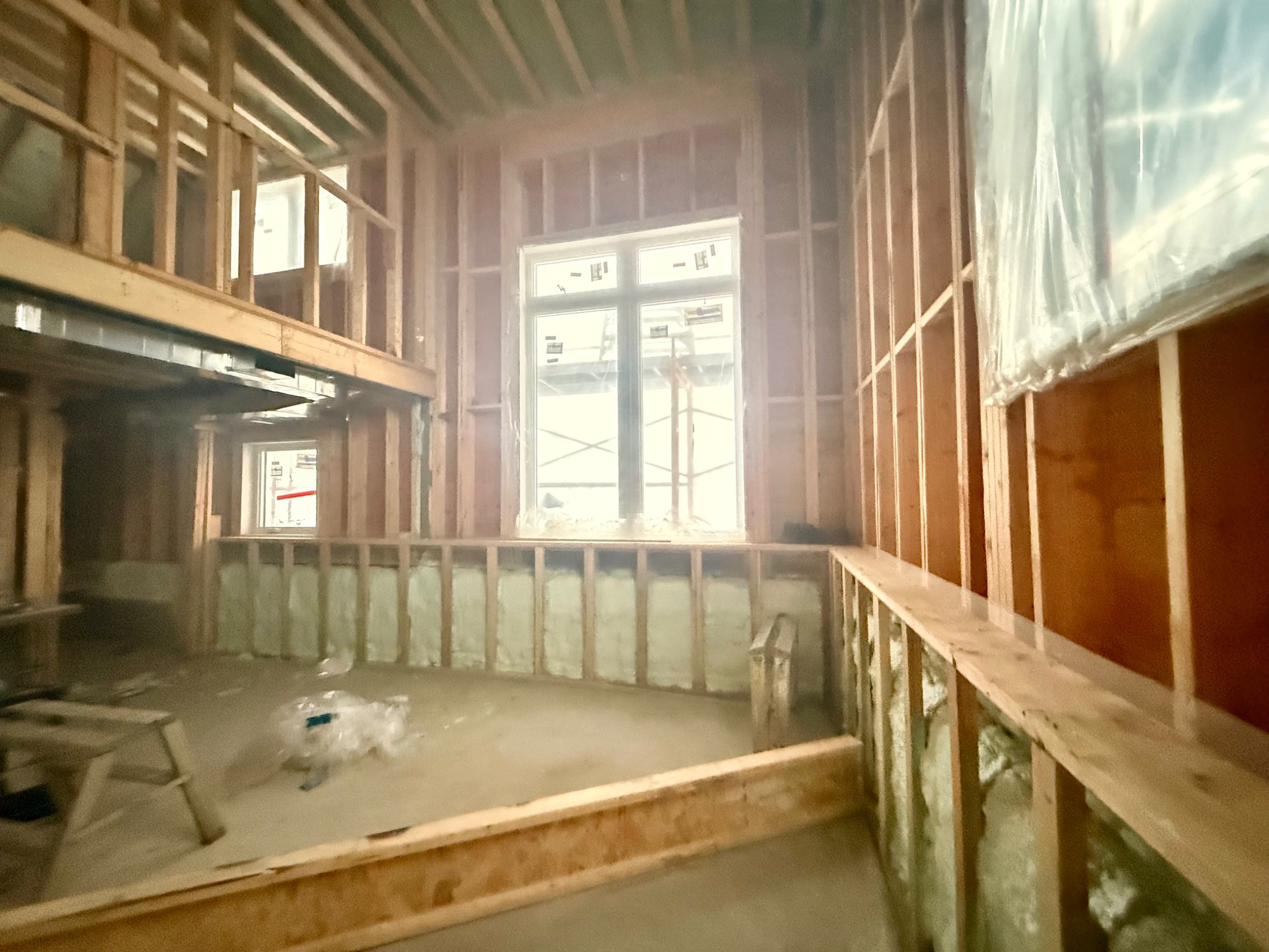 Spray-applied insulation installed within exterior wall framing